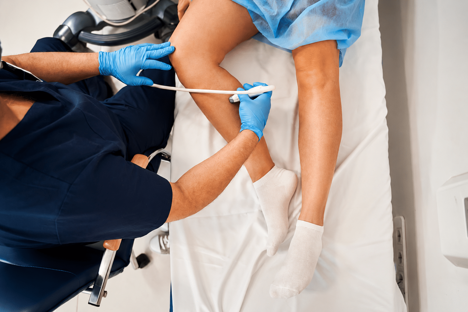 Medical professional performing vein ultrasound mapping on a patient’s leg for diagnostic evaluation.